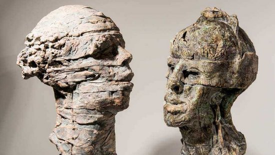 Bild zweier surrealer Kopfskulpturen aus Ton von Kuno Lange